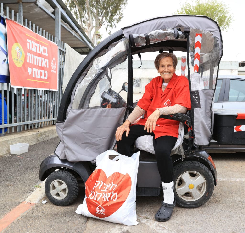 Savfta Malka - Holocaust Survivor who is our oldest daily volunteer with a bag to deliver to someone in need